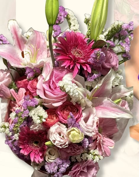 Pink bouquet with lily buds, fuchsia gerberas, and roses with lavender statice